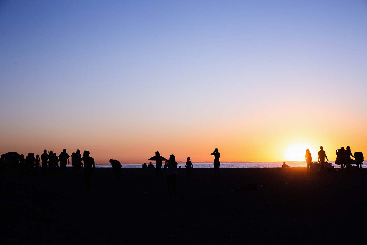 nature silhouette of people near body of water during golden hour outdoors