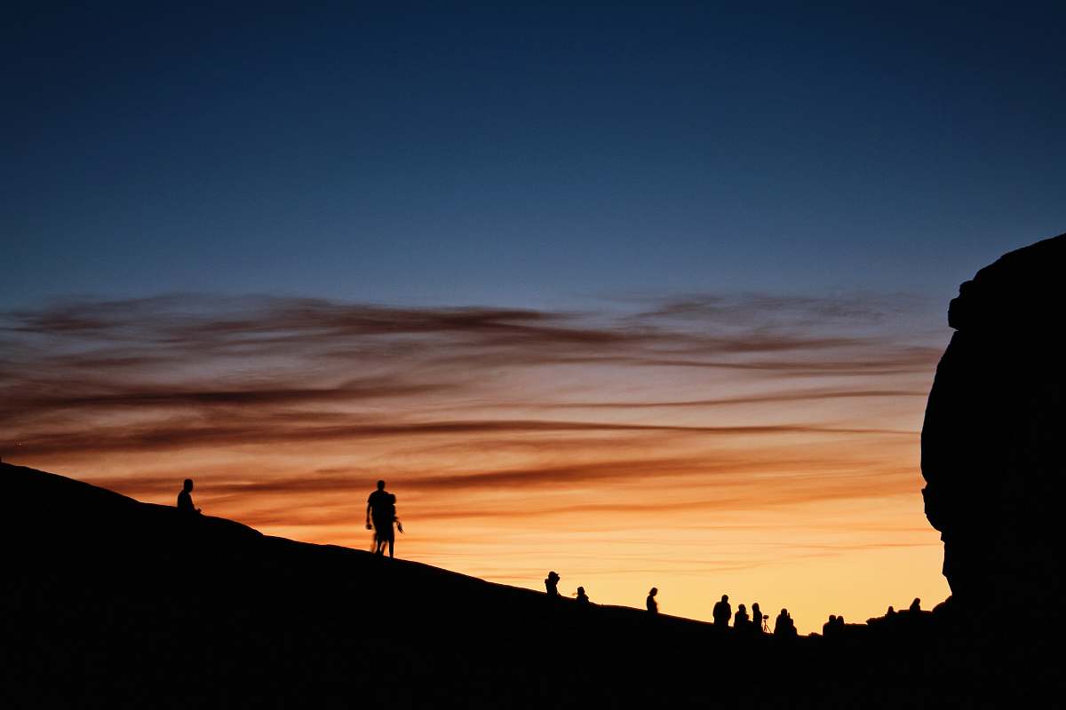 sky silhouette of people on mountain under blue sky during sunset sunrise