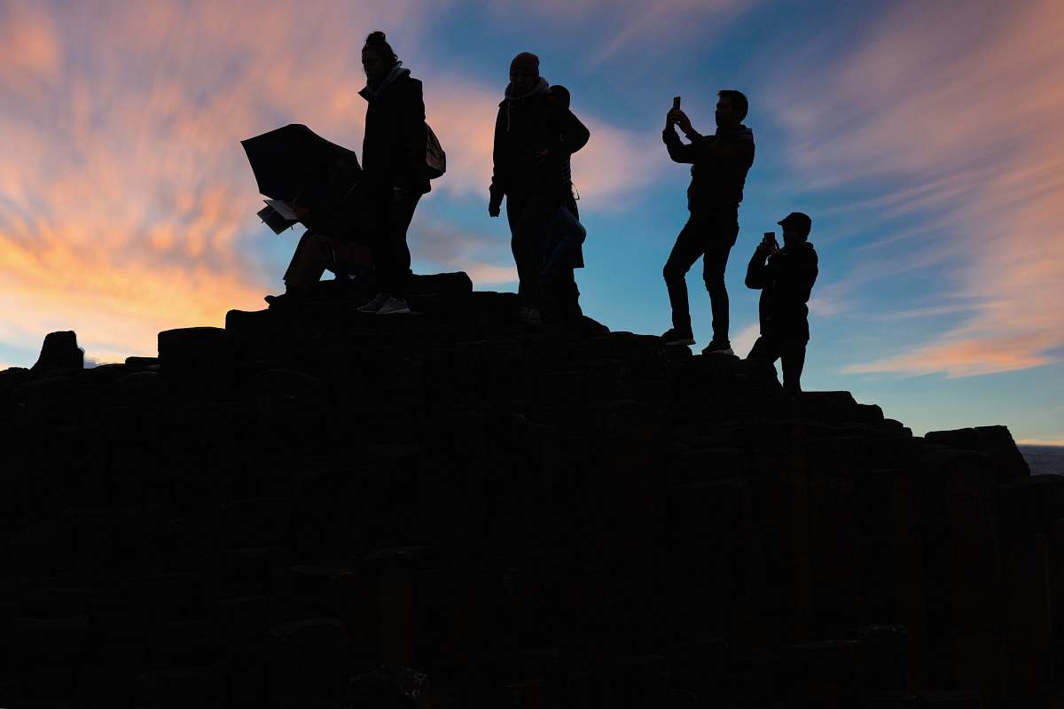 person silhouette of people standing on top of mountain during sunset human