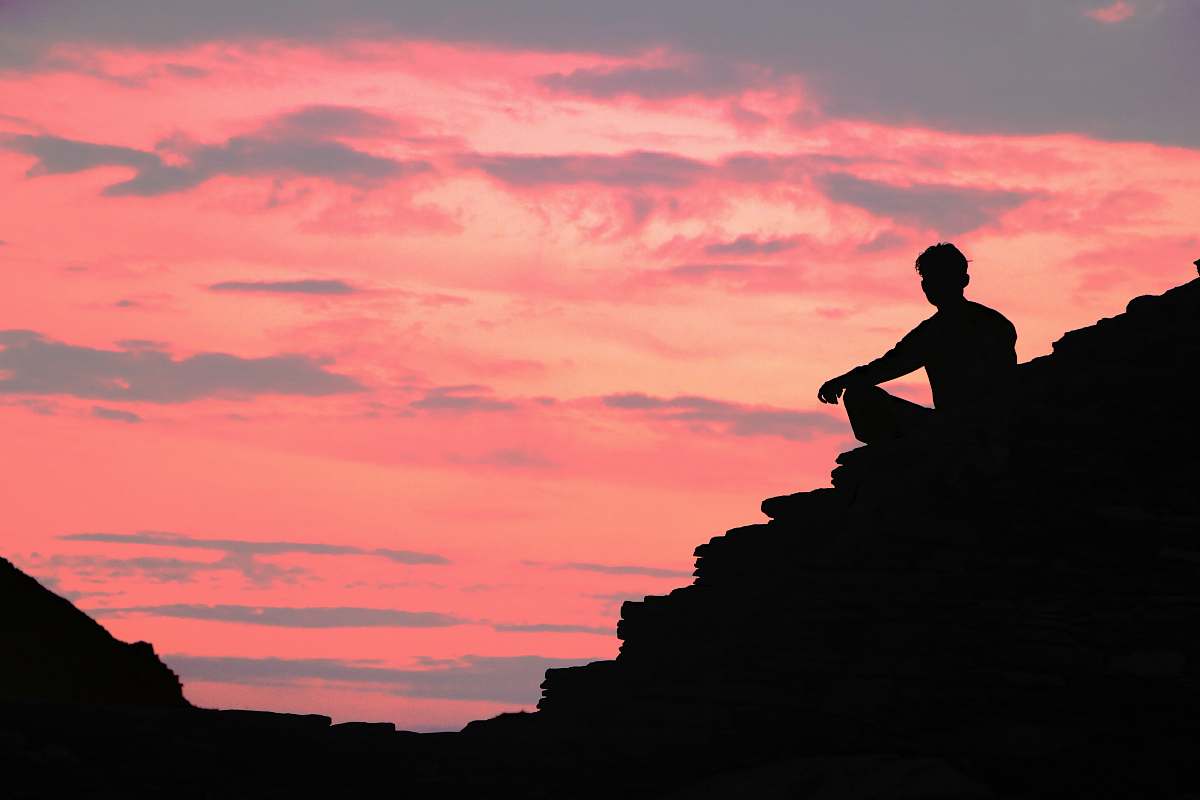 nature silhouette of person across orange sky outdoors