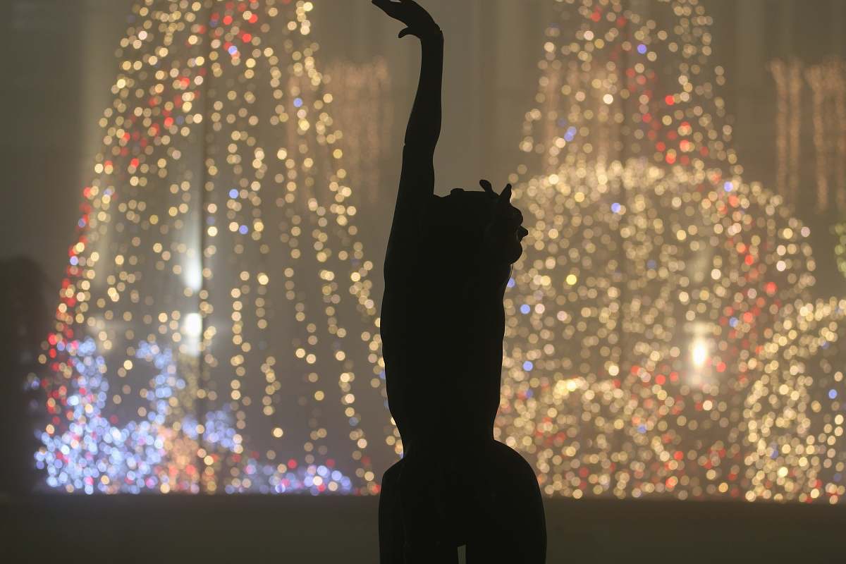 flare silhouette of person dancing light