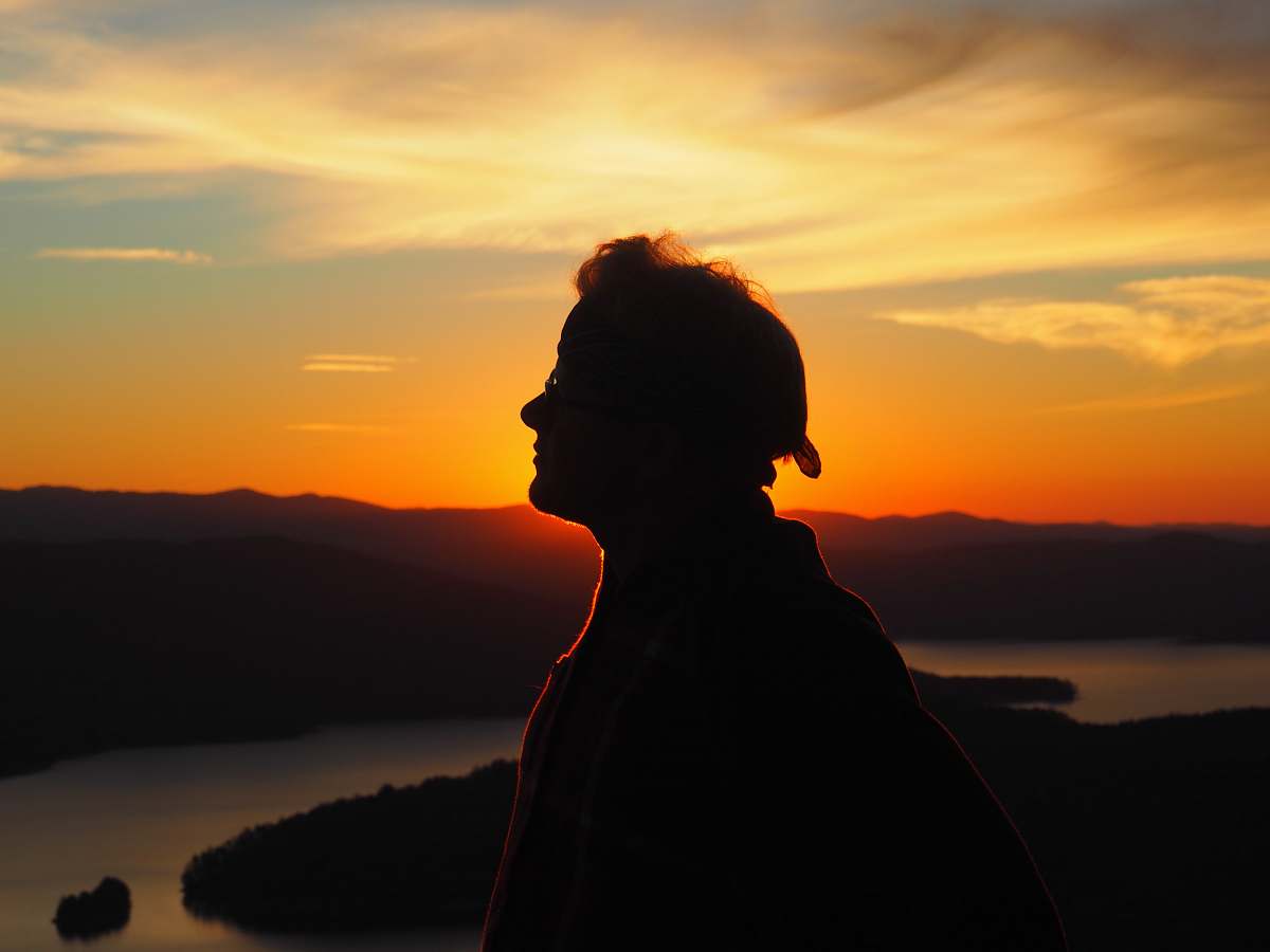 nature silhouette of person facing right side during golden hour sunset