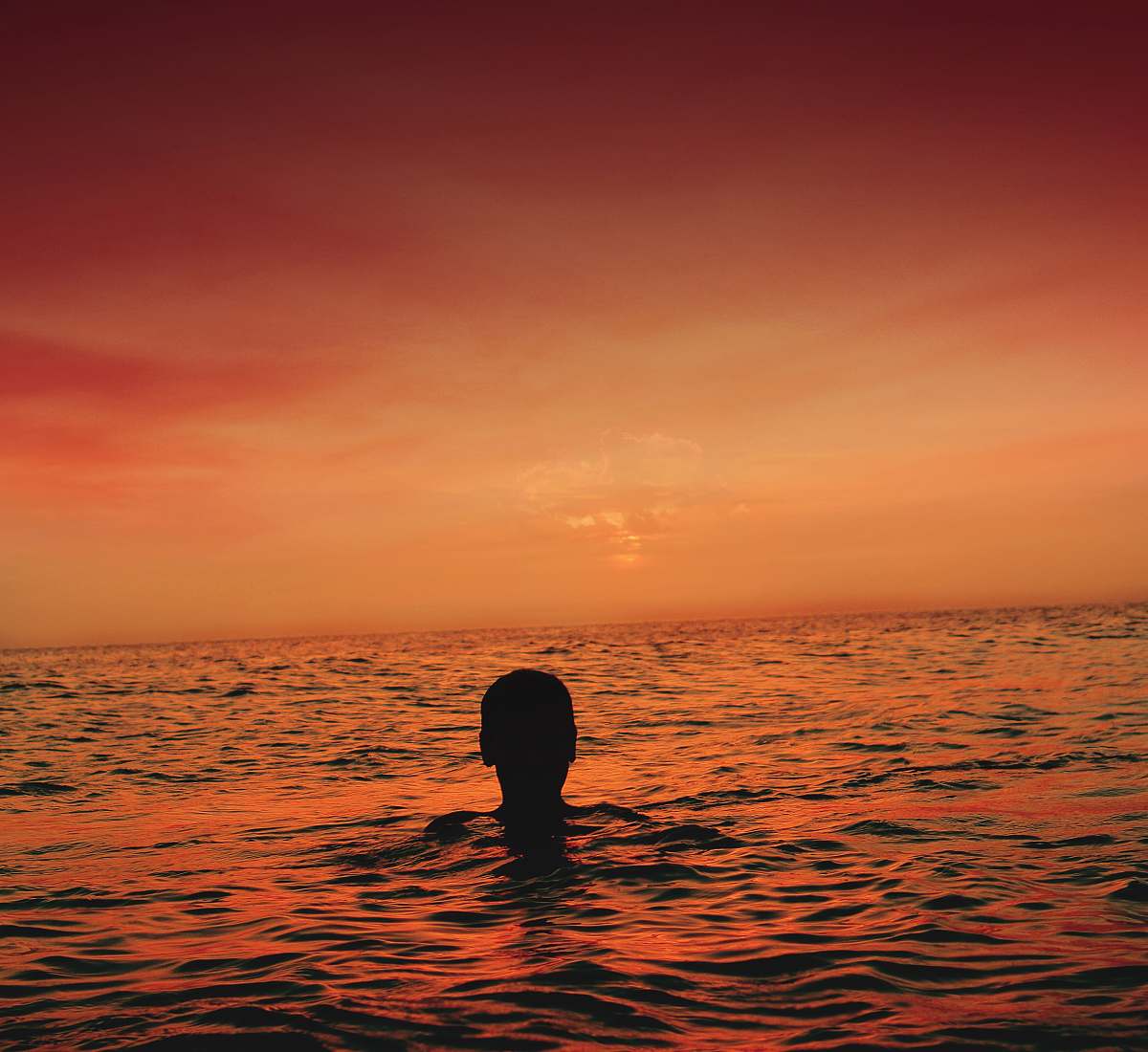 morocco silhouette of person in ocean during sunset orange