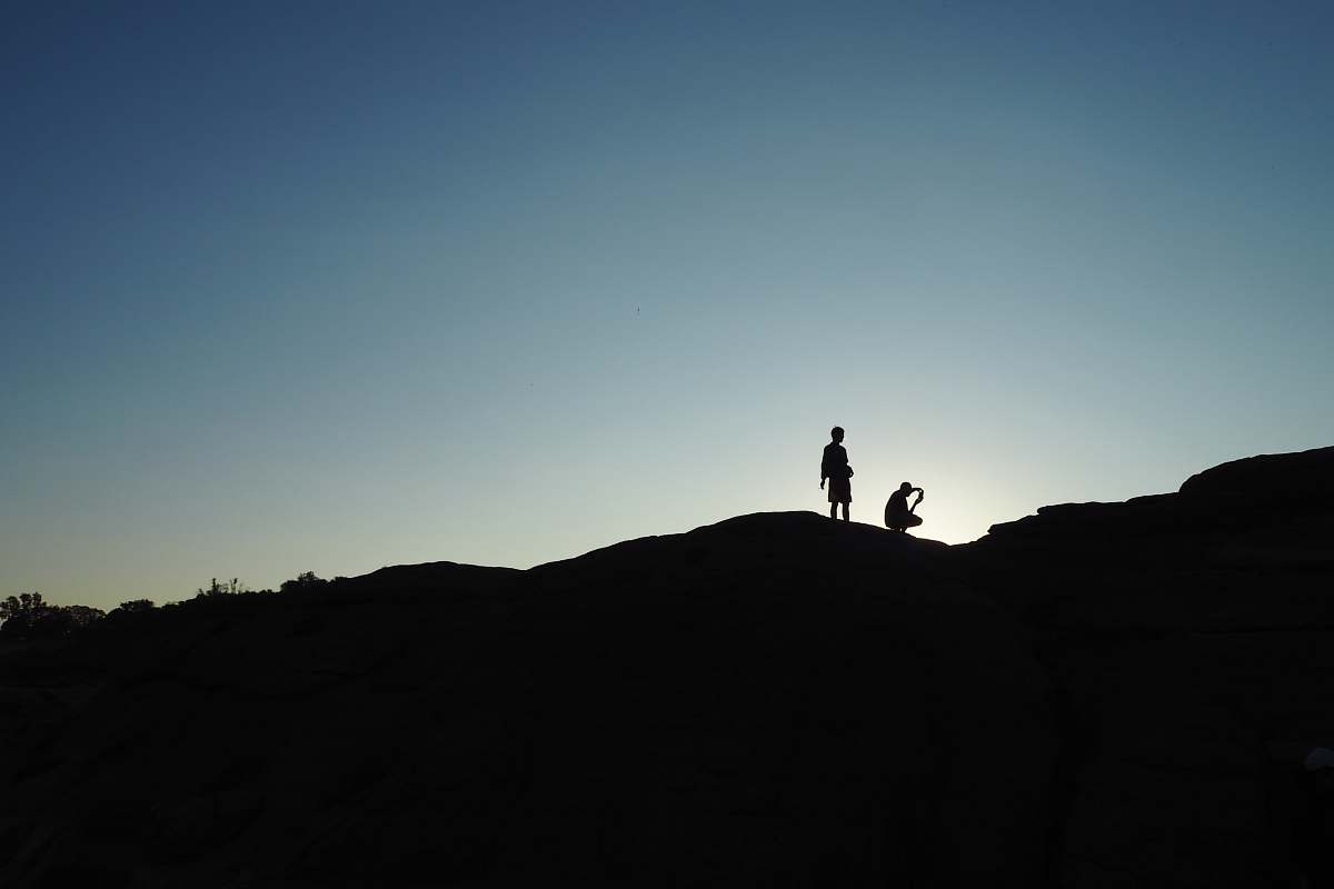 people silhouette of person on hill grey