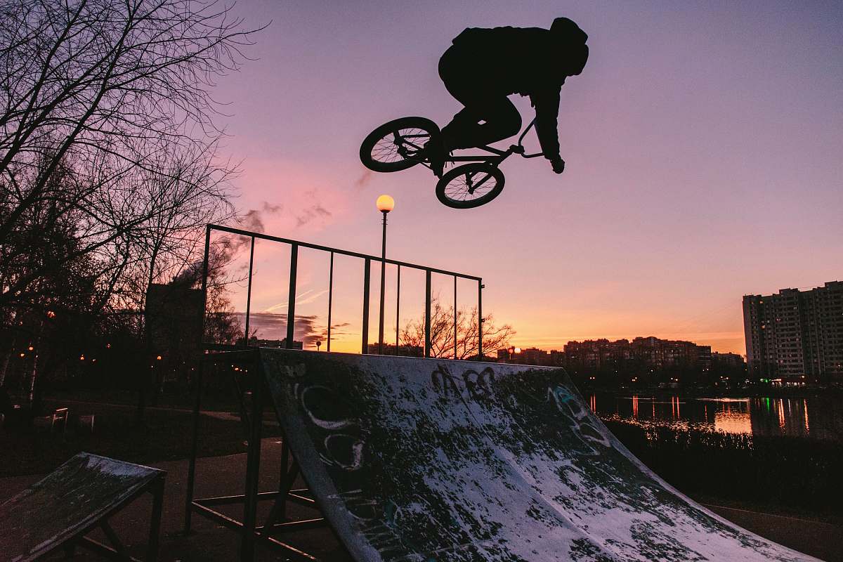 bicycle silhouette of person riding bike while doing tricks bike