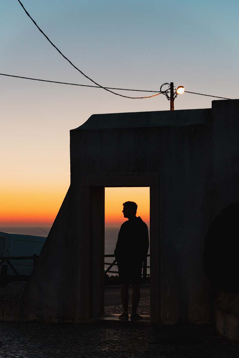 person silhouette of person standing near open door human