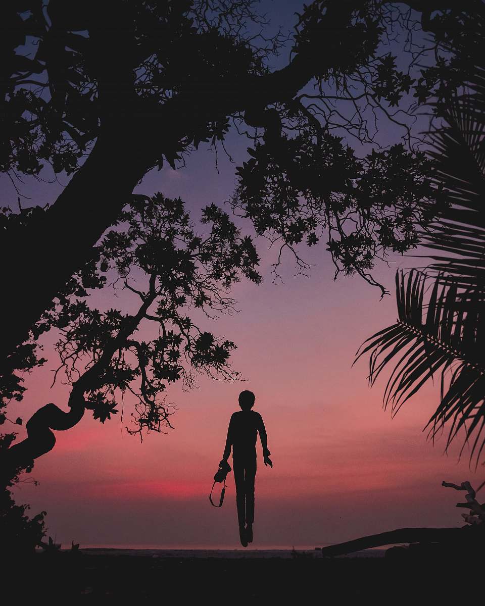 nature silhouette of person standing on seashore outdoors
