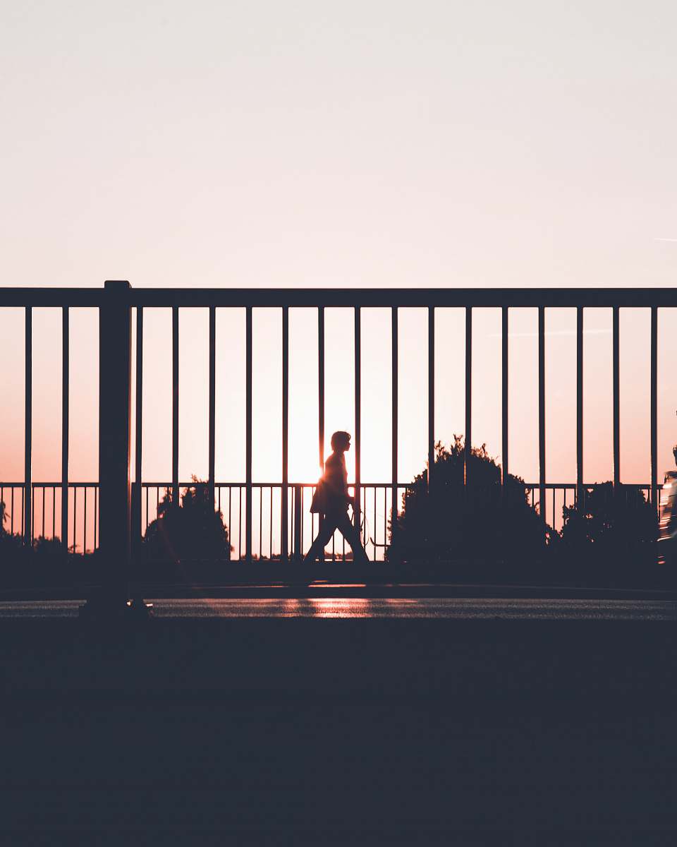 walking silhouette of person walking on roadside during sunset vangede st.
