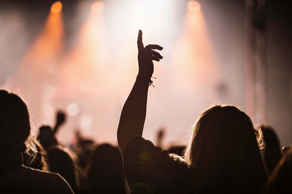 worship silhouette of person with hand up concert
