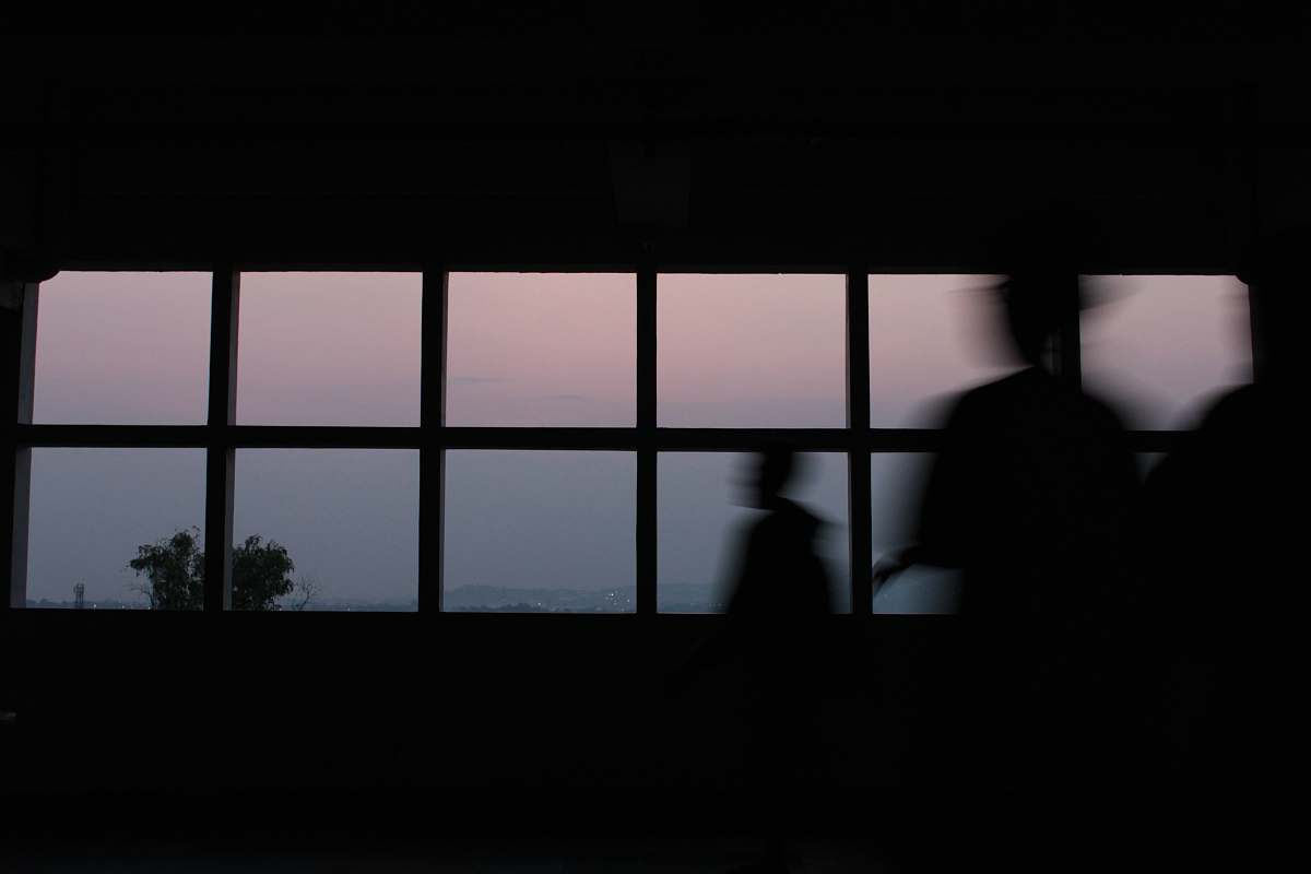 window silhouette of standing near window unika soegijapranata semarang