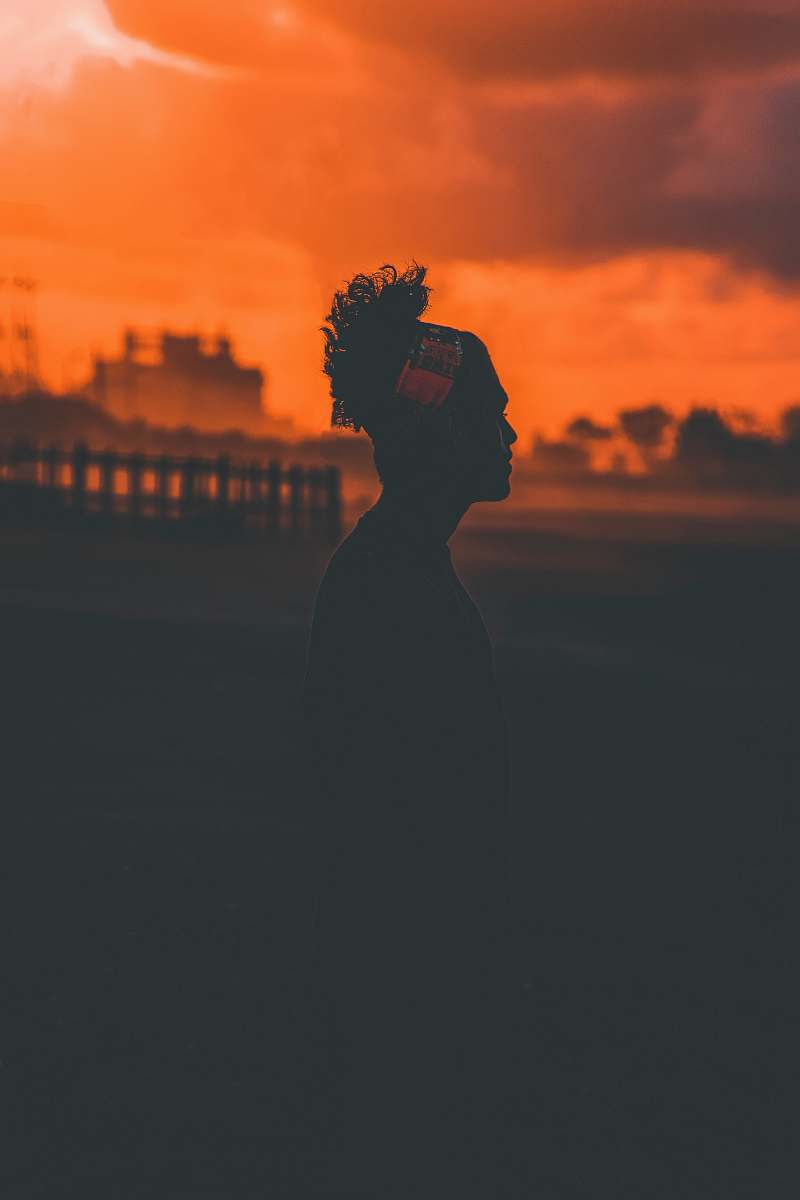 nature silhouette of standing person during golden hour outdoors