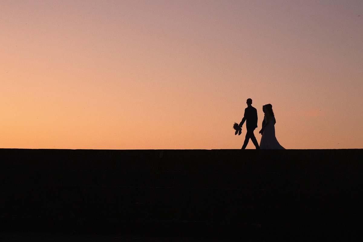 person silhouette of two people during golden hour human