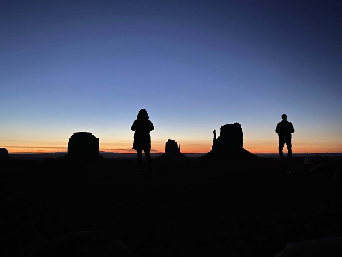 person silhouette of two person under blue sky human