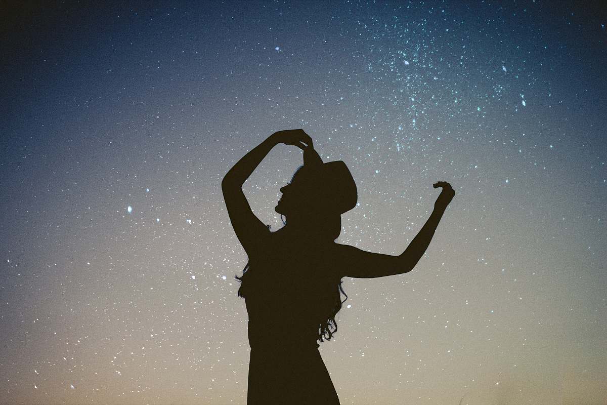 people silhouette of woman holding hat in blue and gray nebula woman