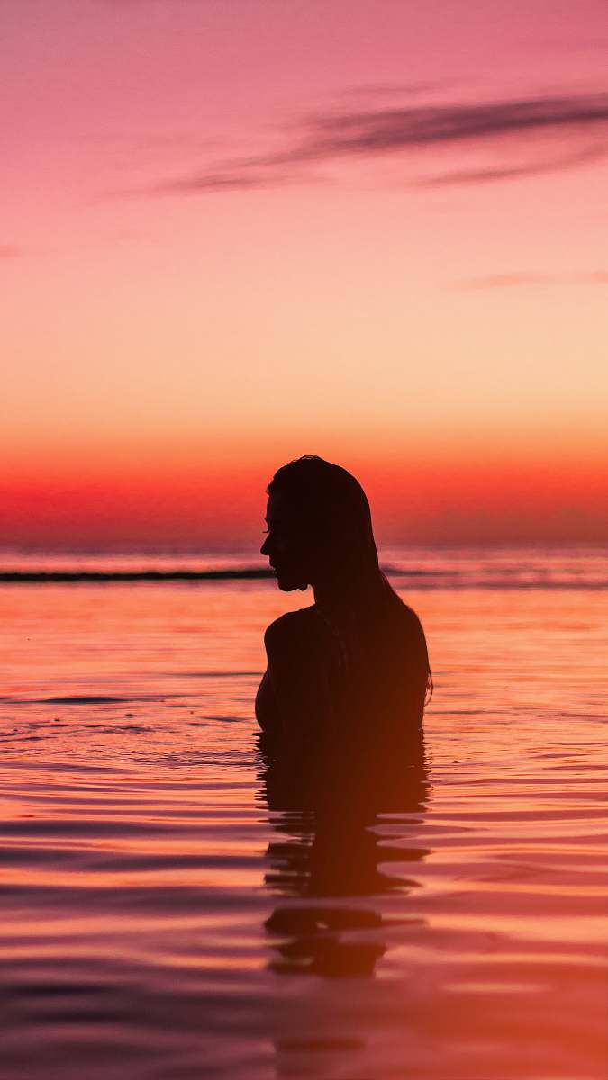 outdoors silhouette of woman in body of water standing