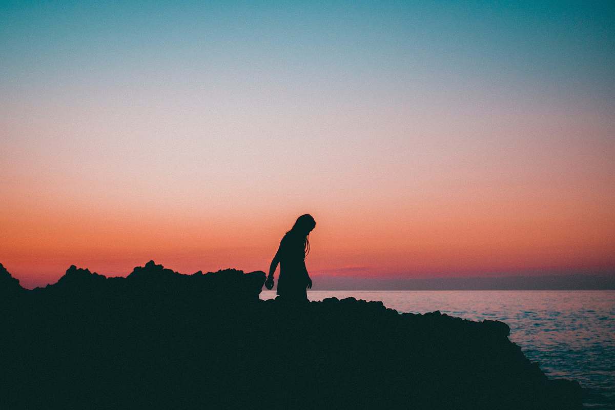 standing silhouette of woman near body of water person