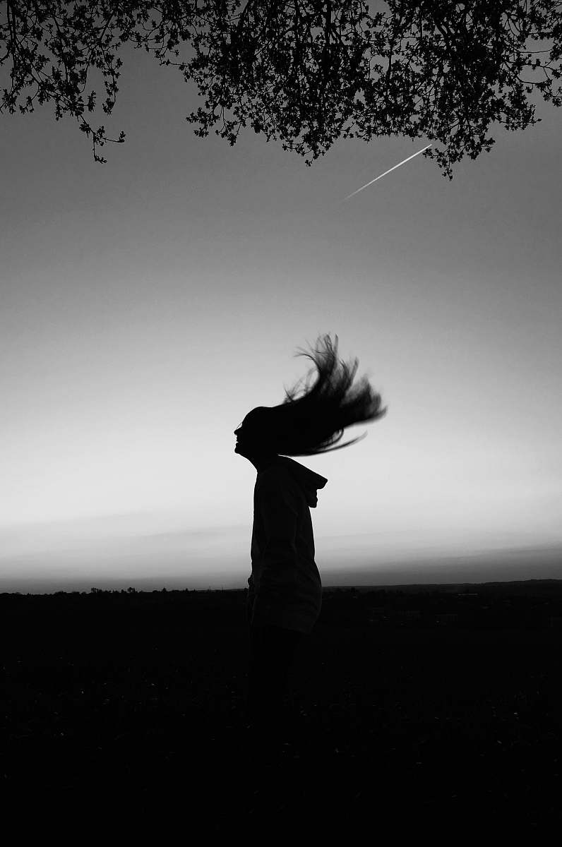 human silhouette of woman waving hair black-and-white