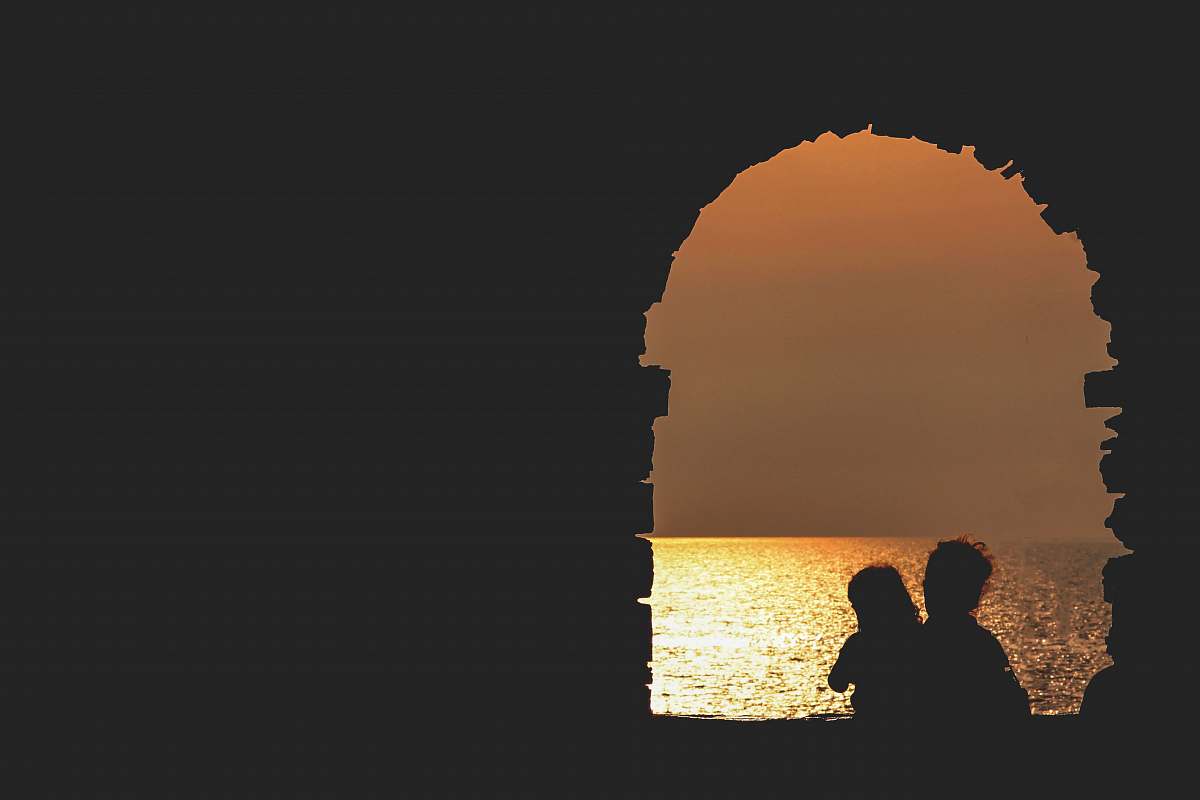 arch silhouette on building facing sea sea