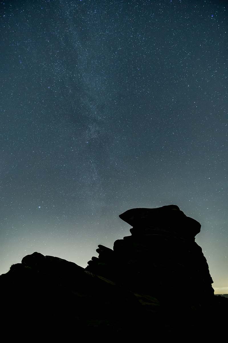 grey silhouette on rocky mountain night