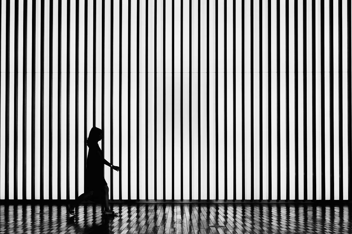 black-and-white silhouette on walking woman tokyo