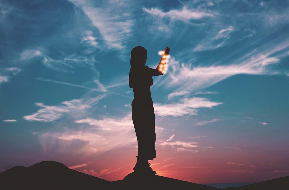 human silhouette on woman standing on rock person