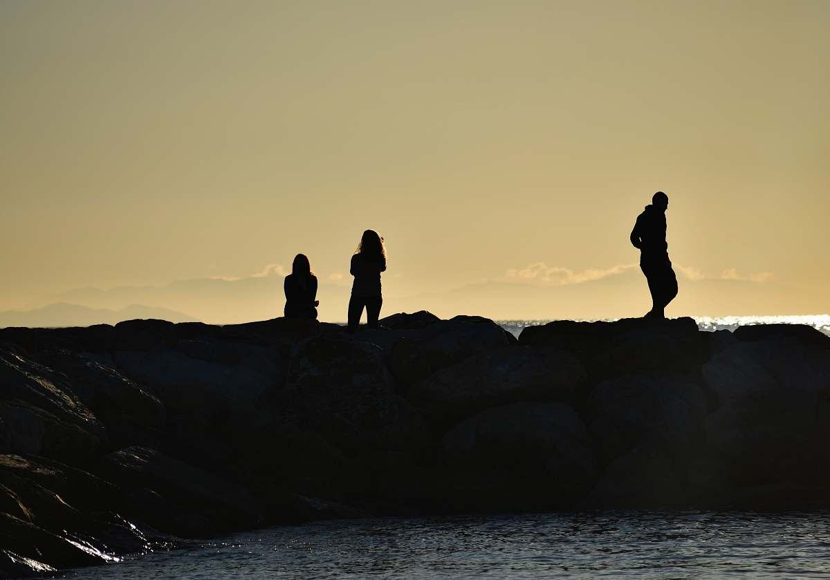 ocean silhouette people near sea during sunset sea