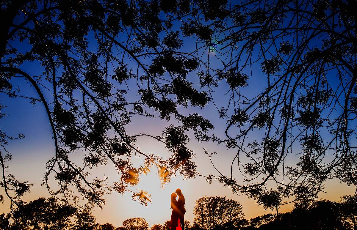 love silhouette photo of man and woman hugging each other couple