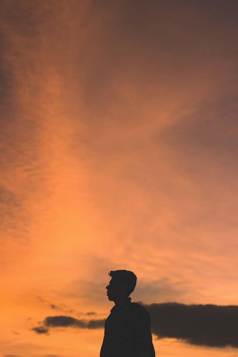 human silhouette photo of man during golden hour person