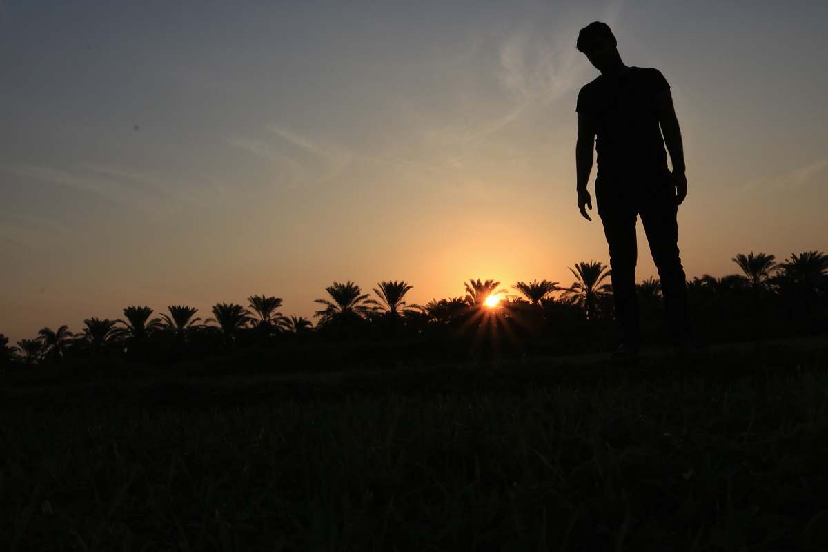 human silhouette photo of man standing on ground person