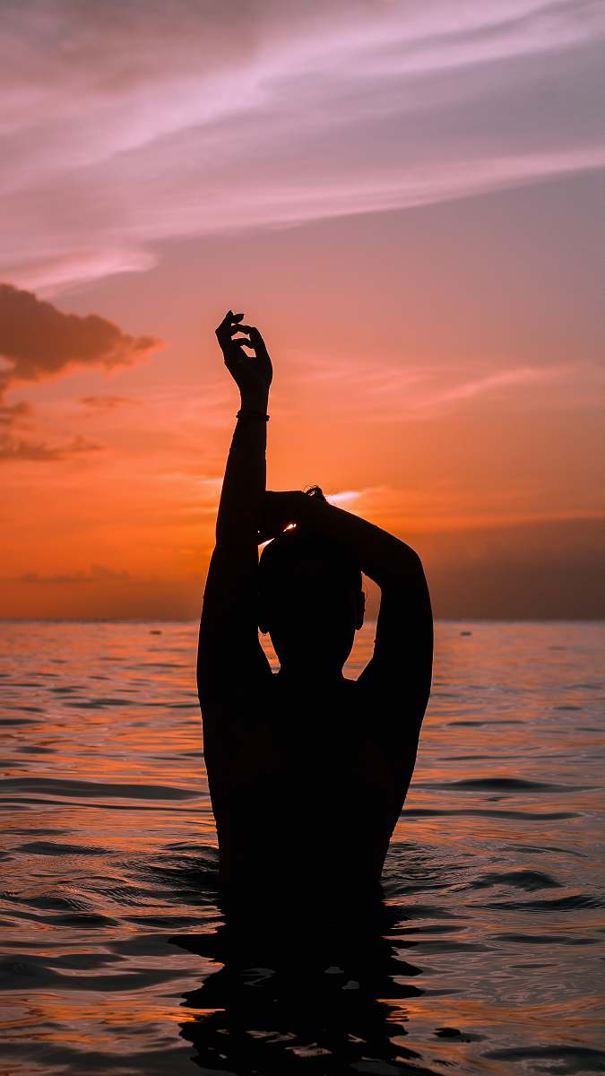 nature silhouette photo of person in body of water outdoors
