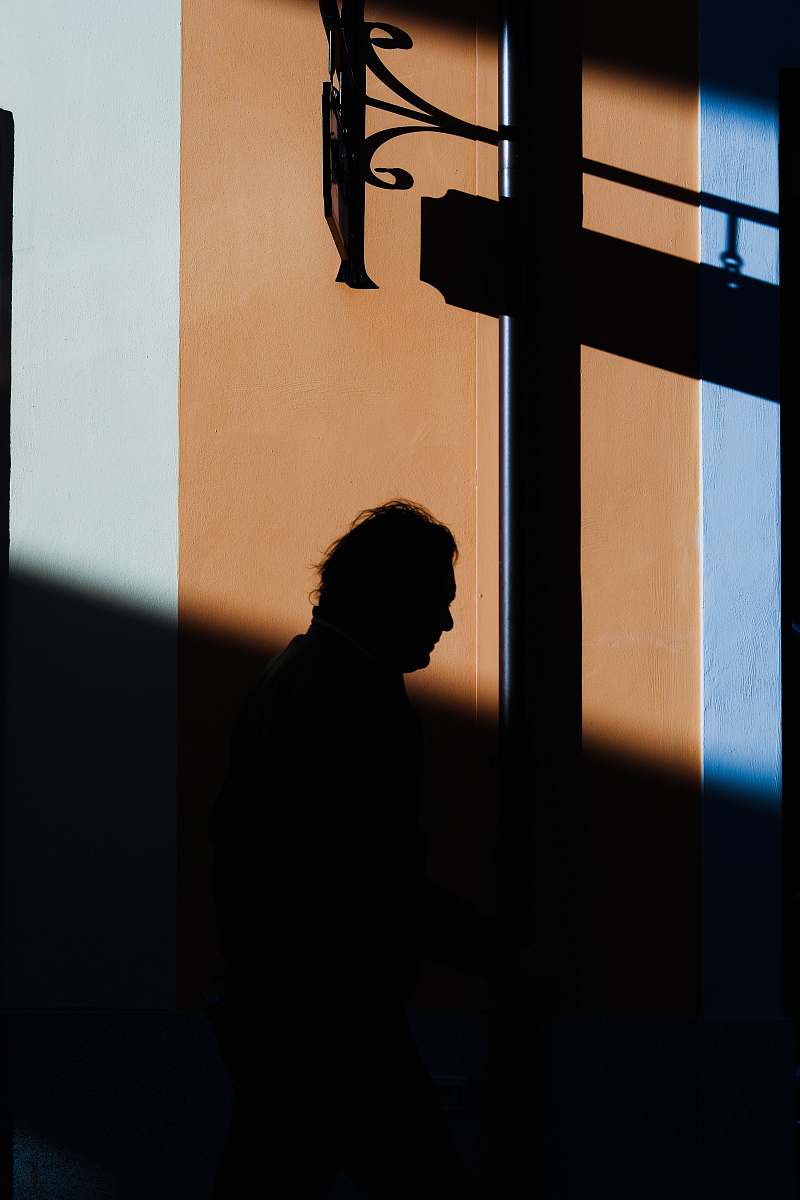 human silhouette photo of person under black metal frame person