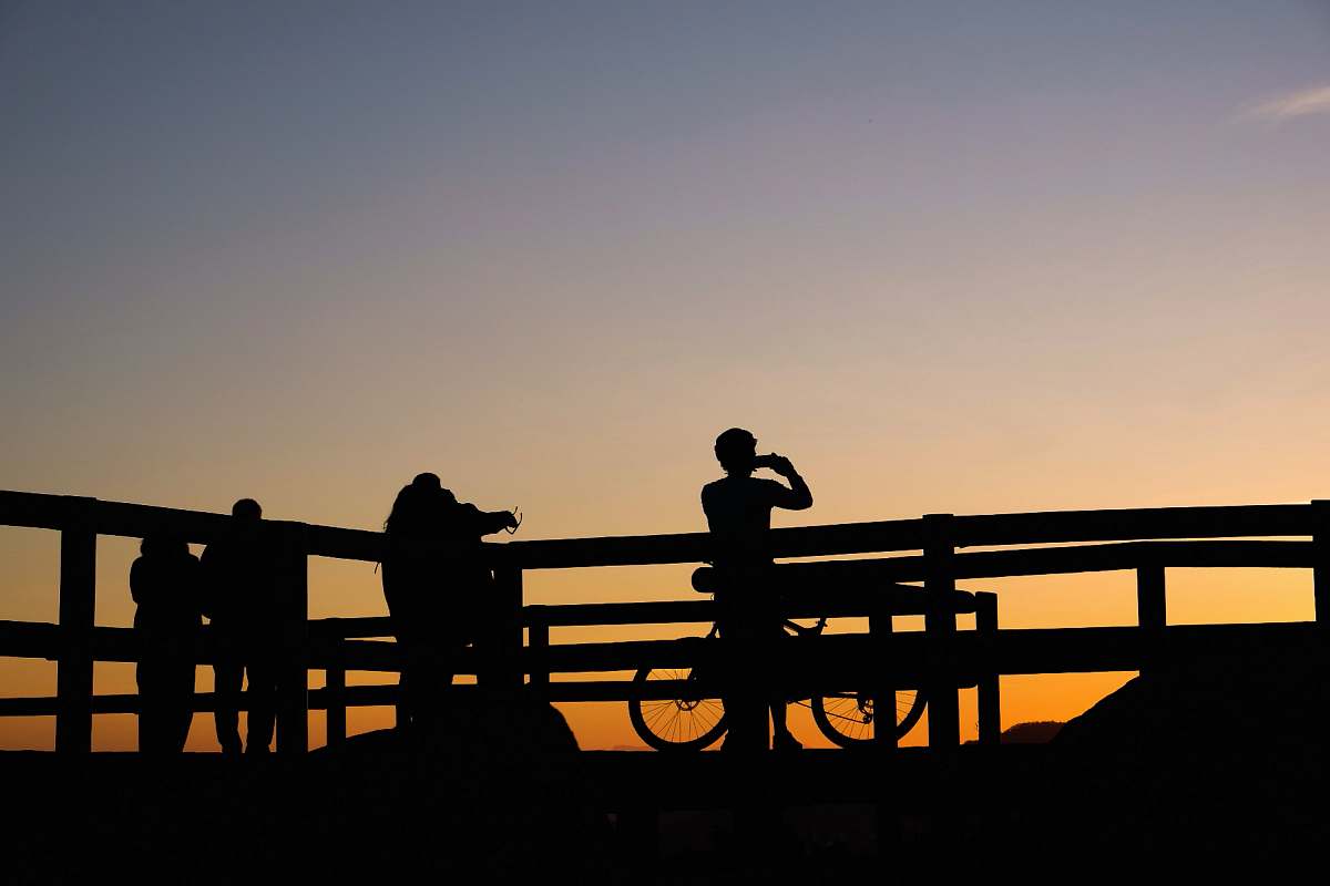 people silhouette photo of persons taking photo of sunset person