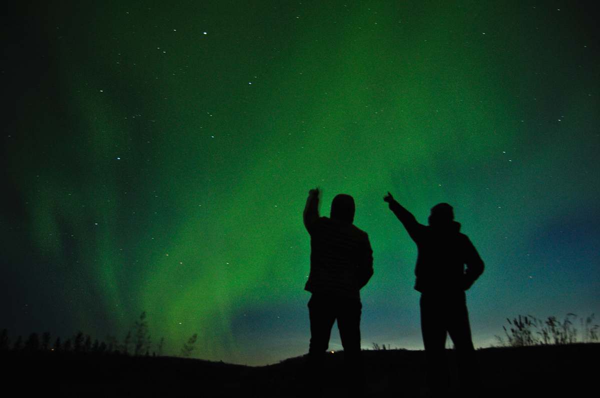 human silhouette photo of two person looking up the sky person