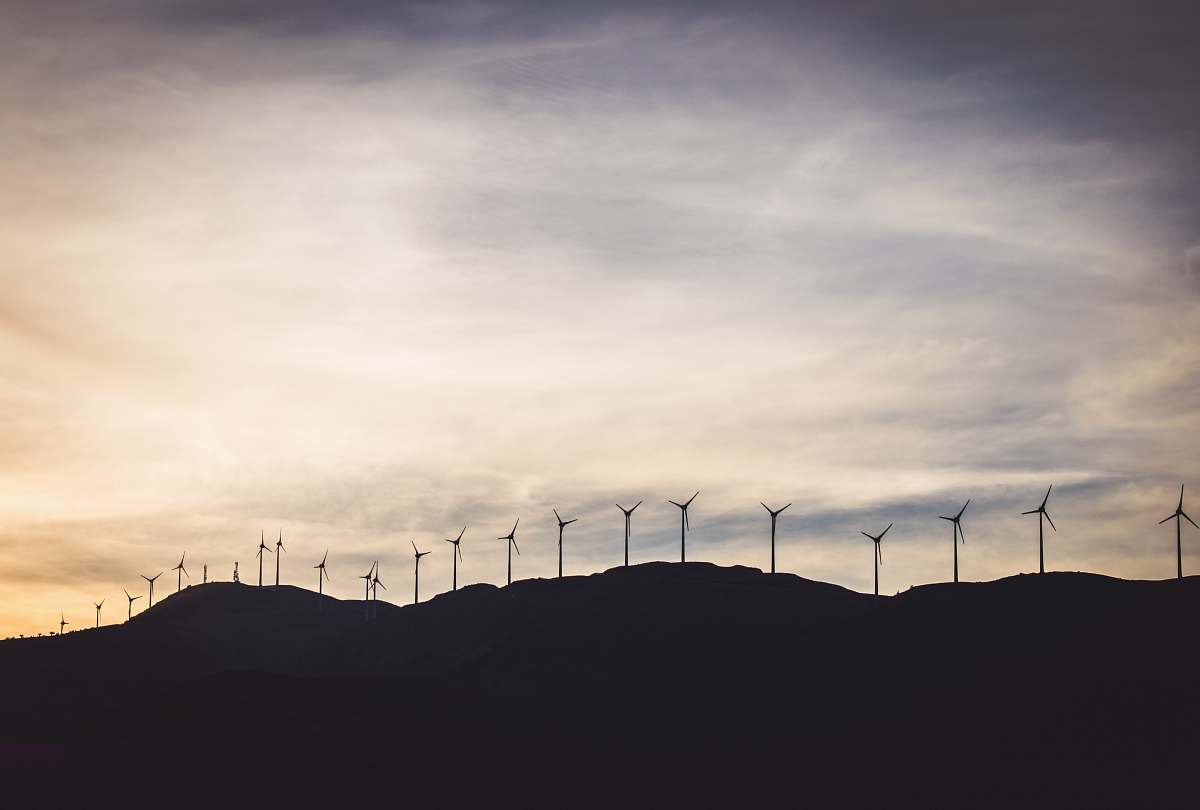 greece silhouette photo of wind turbines on hill turbine