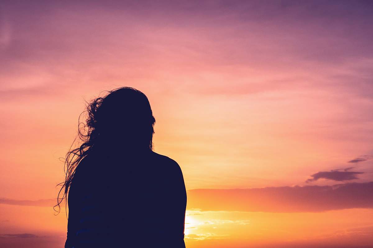 person silhouette photo of woman's back nature
