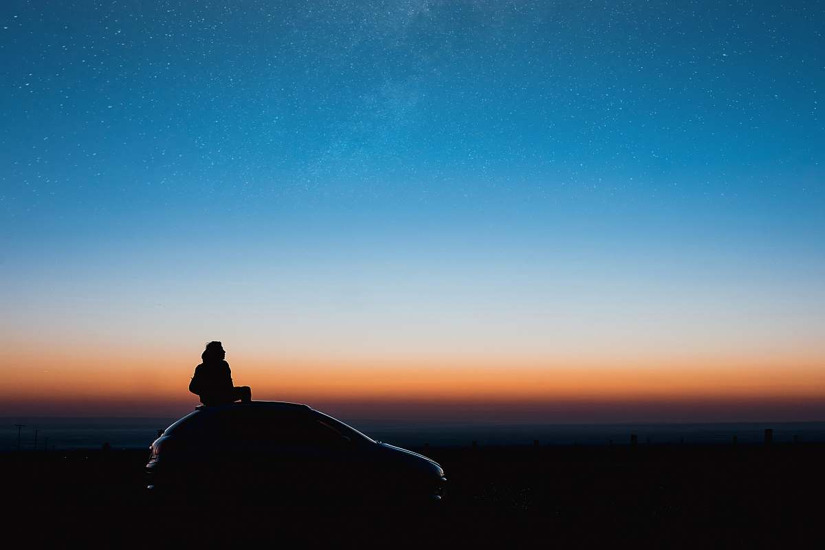 nature silhouette photography of a car during golden hour outdoors