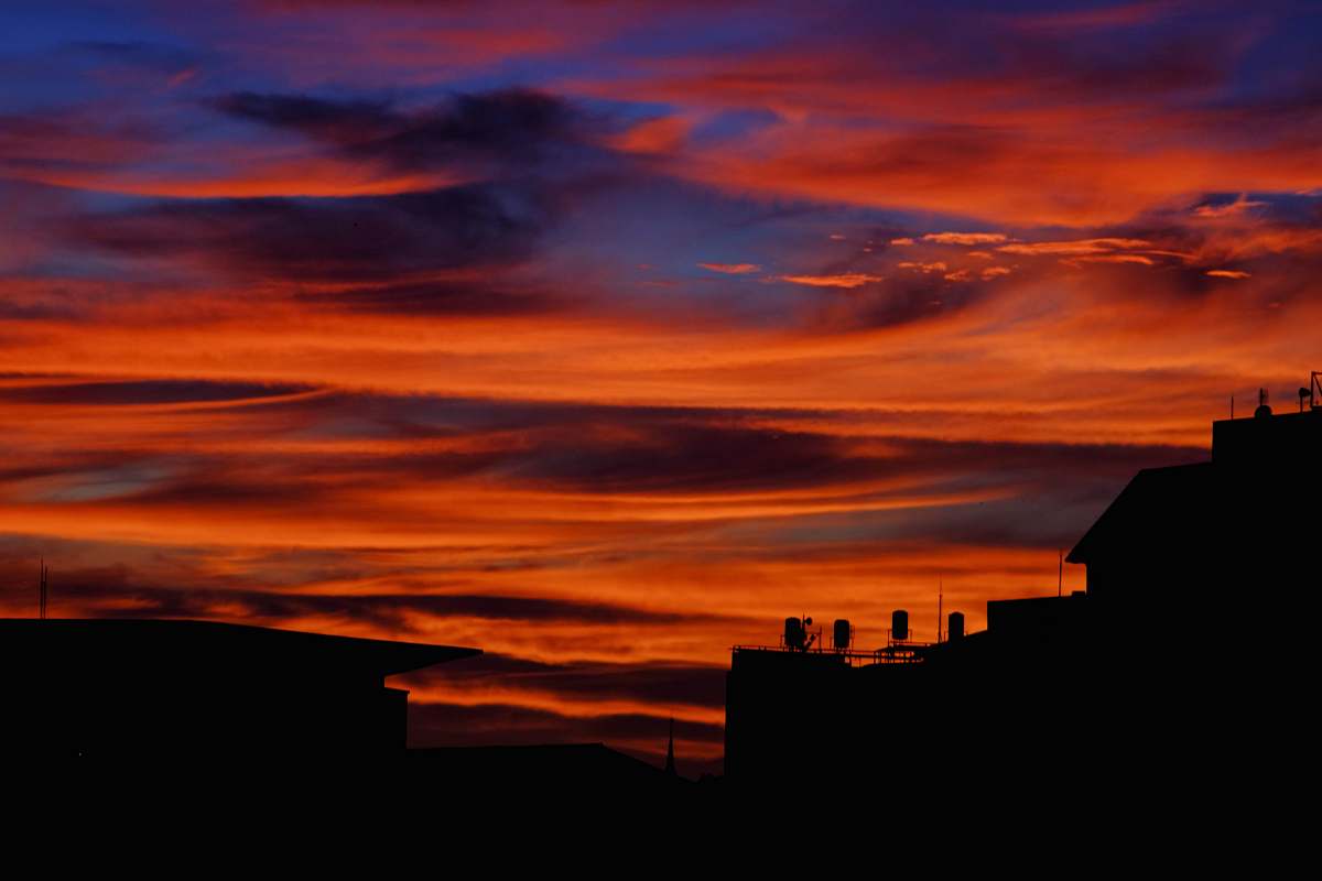 nature silhouette photography of buildings during sunset dawn
