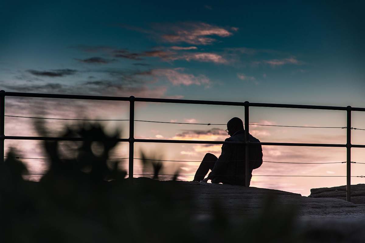 human silhouette photography of person sitting person