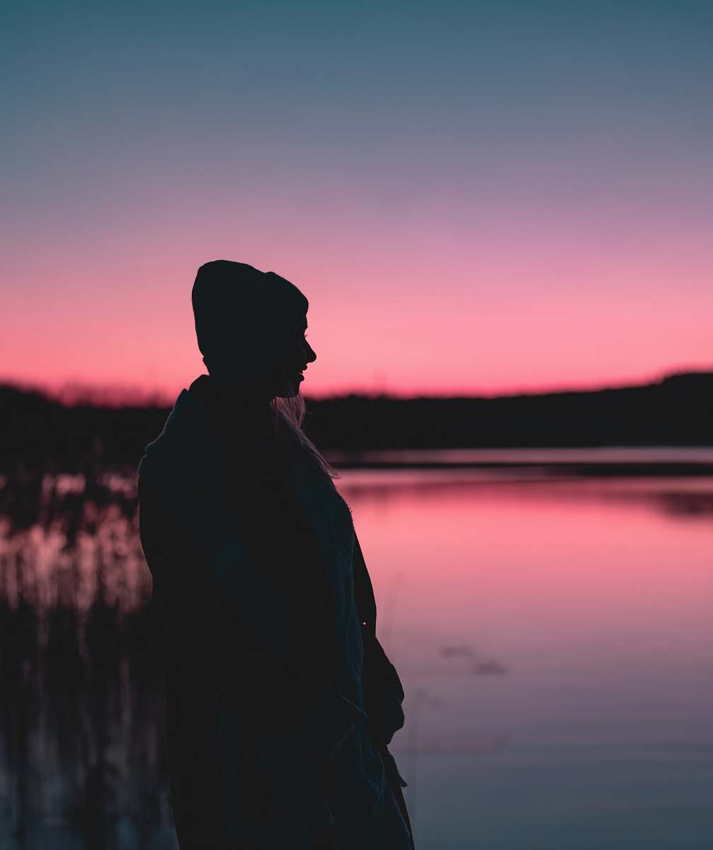 outdoors silhouette photography of person standing near body of water nature