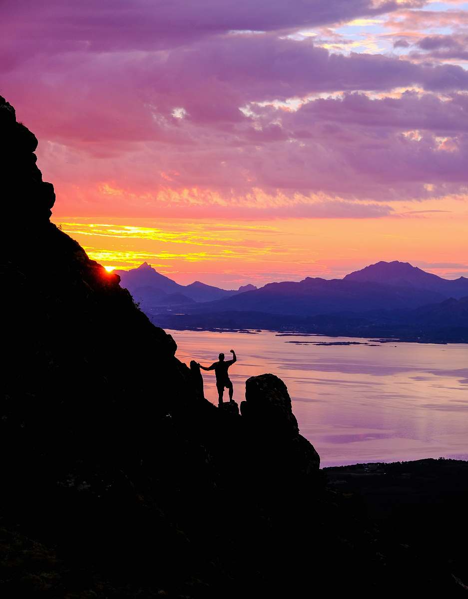 nature silhouette photography of person standing on cliff outdoors