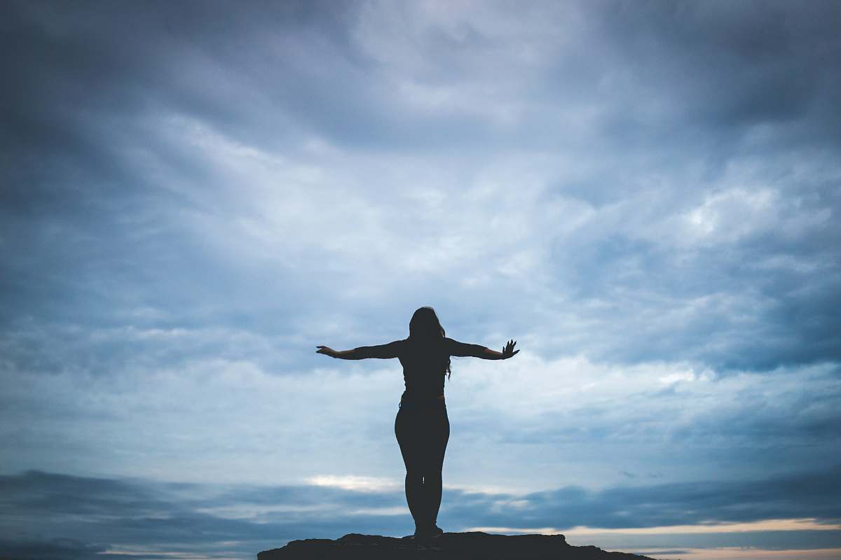 flatrock silhouette photography of woman standing on rock canada