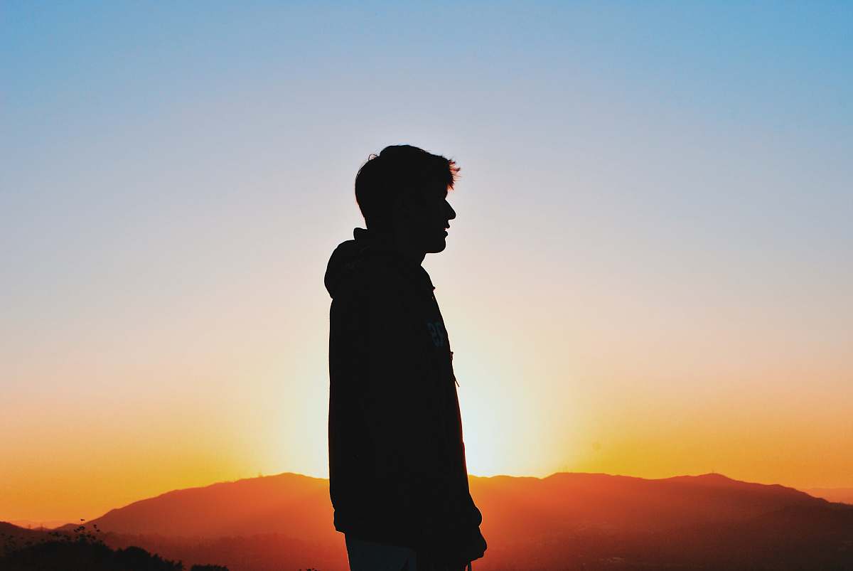 human silhuoette photo of man under clear blue sky standing