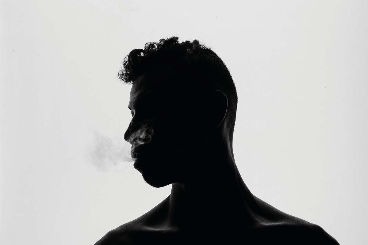 black-and-white topless man looking side view head