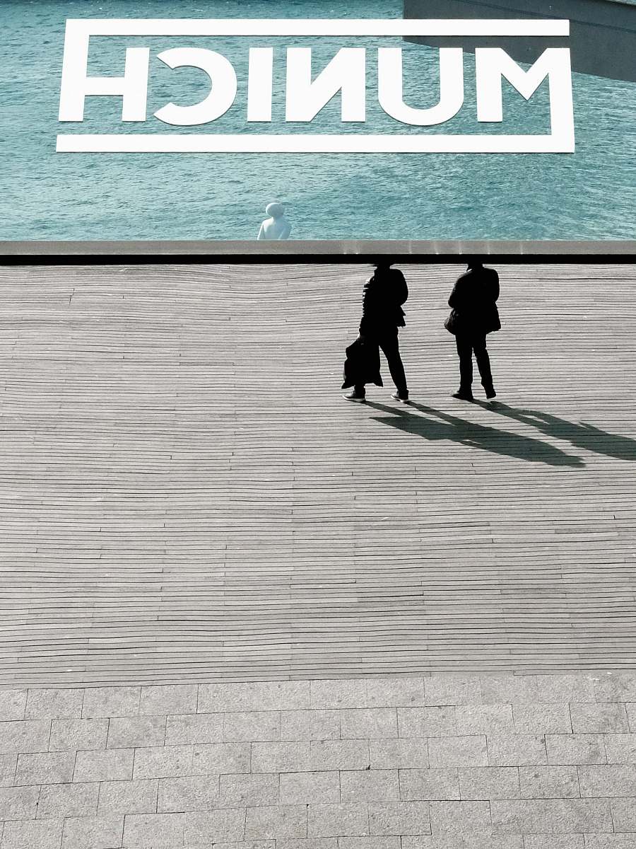 munich two person standing near body of water barcelona