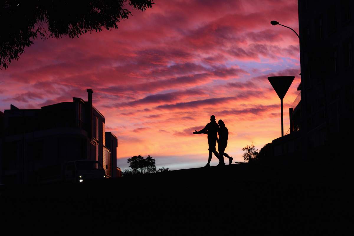 nature two persons walking near building sky