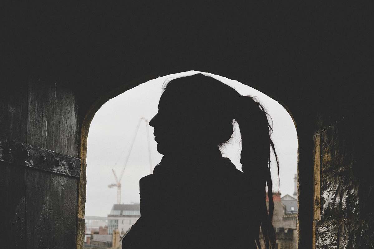 human woman underneath building grey