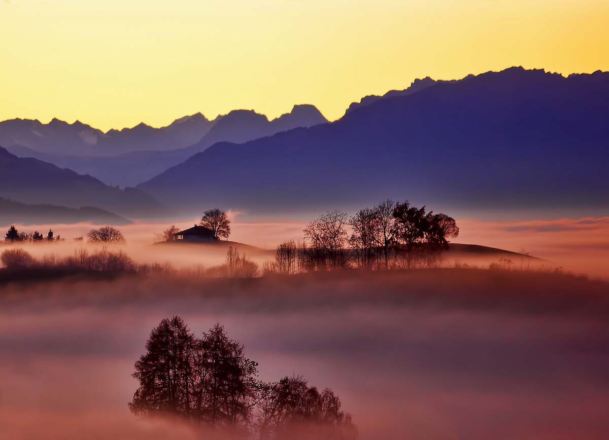sunset aerial photo of foggy trees and mountains sunrise