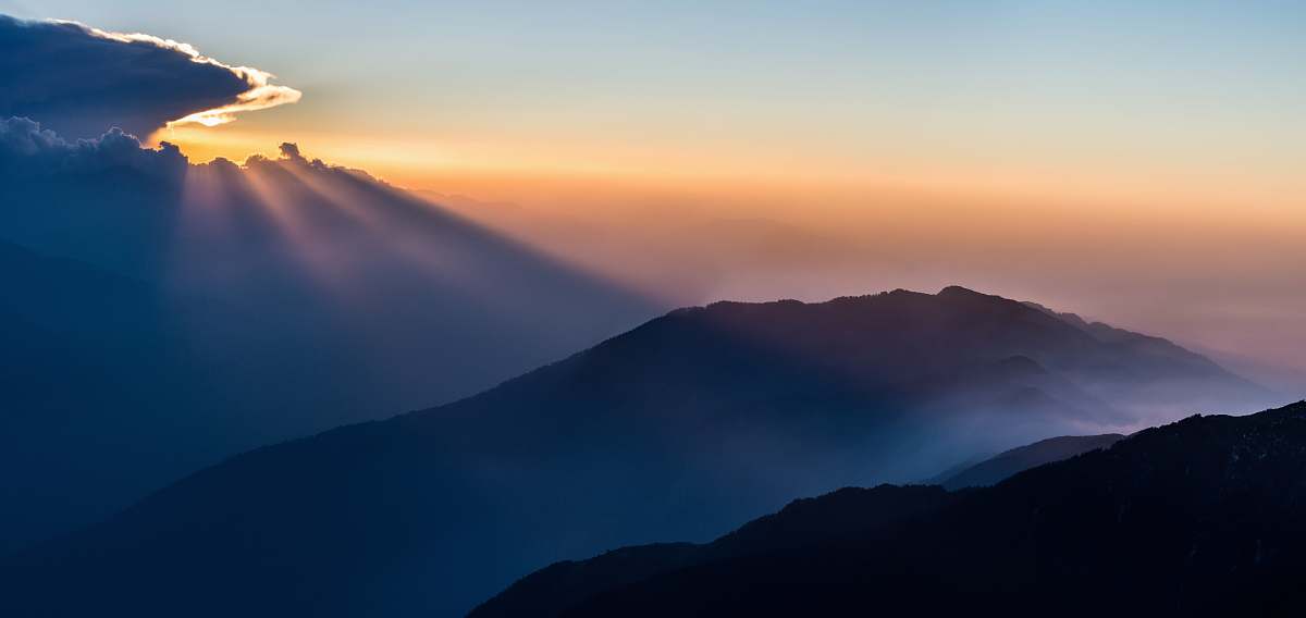 sunset aerial view photography of mountain under clear blue sky during daytime nature
