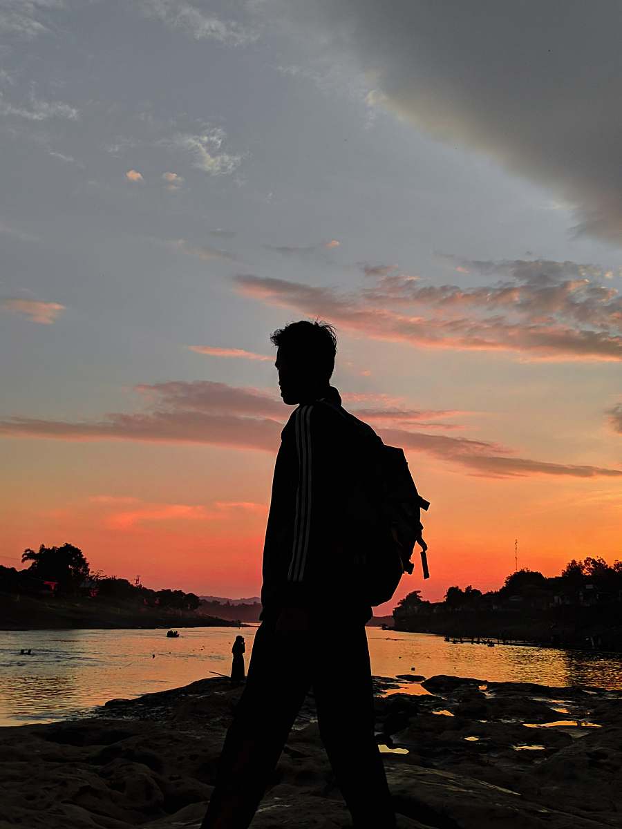 sunset man near shore nature