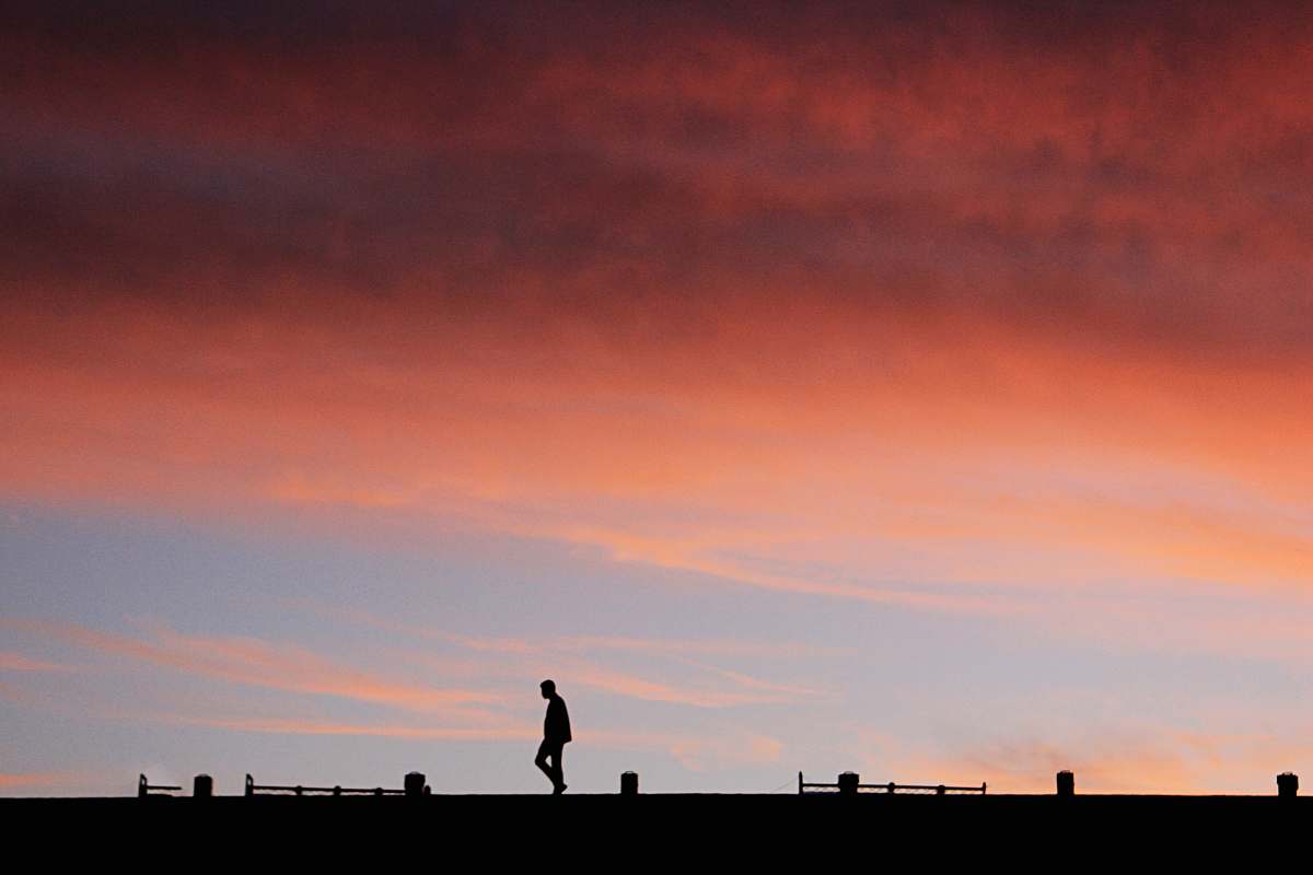 dusk silhouette of man at golden hour dawn